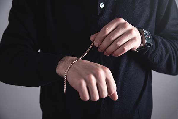 man with gold bracelet