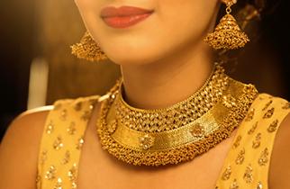 Woman wearing traditional gold necklace and earnings