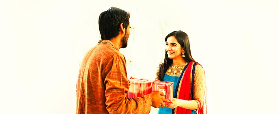 Indian Kids Little Brother Give Gift To His Sister Celebrating Raksha  Bandhan Bhai Dooj With Lots Of Sweet Laddoos In Plate And Shopping Bags  Stock Photo - Download Image Now - iStock