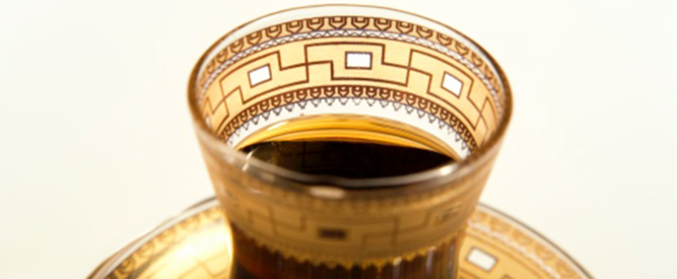 A bowl of sandwich gold glass with a floral design in gold leaf